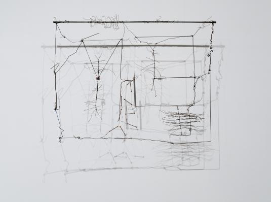 A hanging 3D sculpture consisting of wire, string, wood, and aluminum tubes.