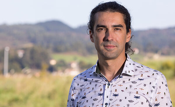 Headshot of David Moreno Mateos outside with mountains behind him.