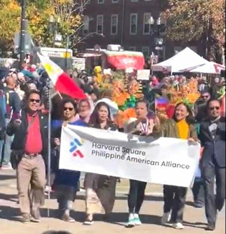 Members of the Harvard Square Philippine American Alliance march down Church Street.  