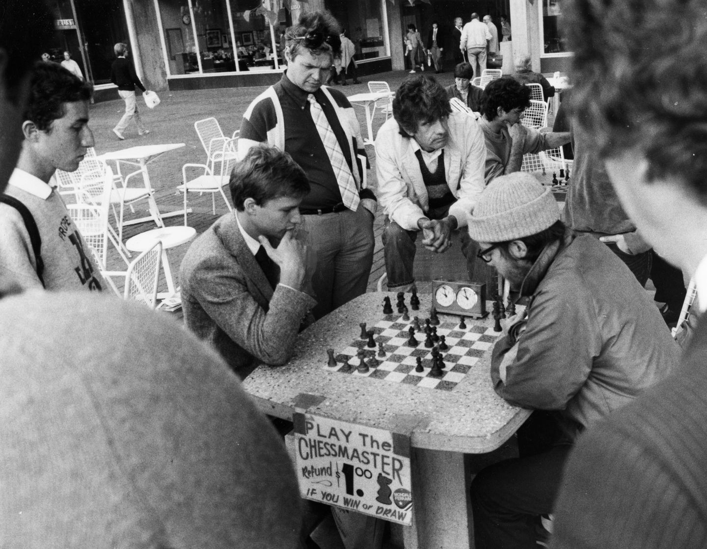 A crowd gathered to watch a man play chess master Murray Turnbull, right, in front of the Holyoke Center in Harvard Square on Oct. 16, 1984.