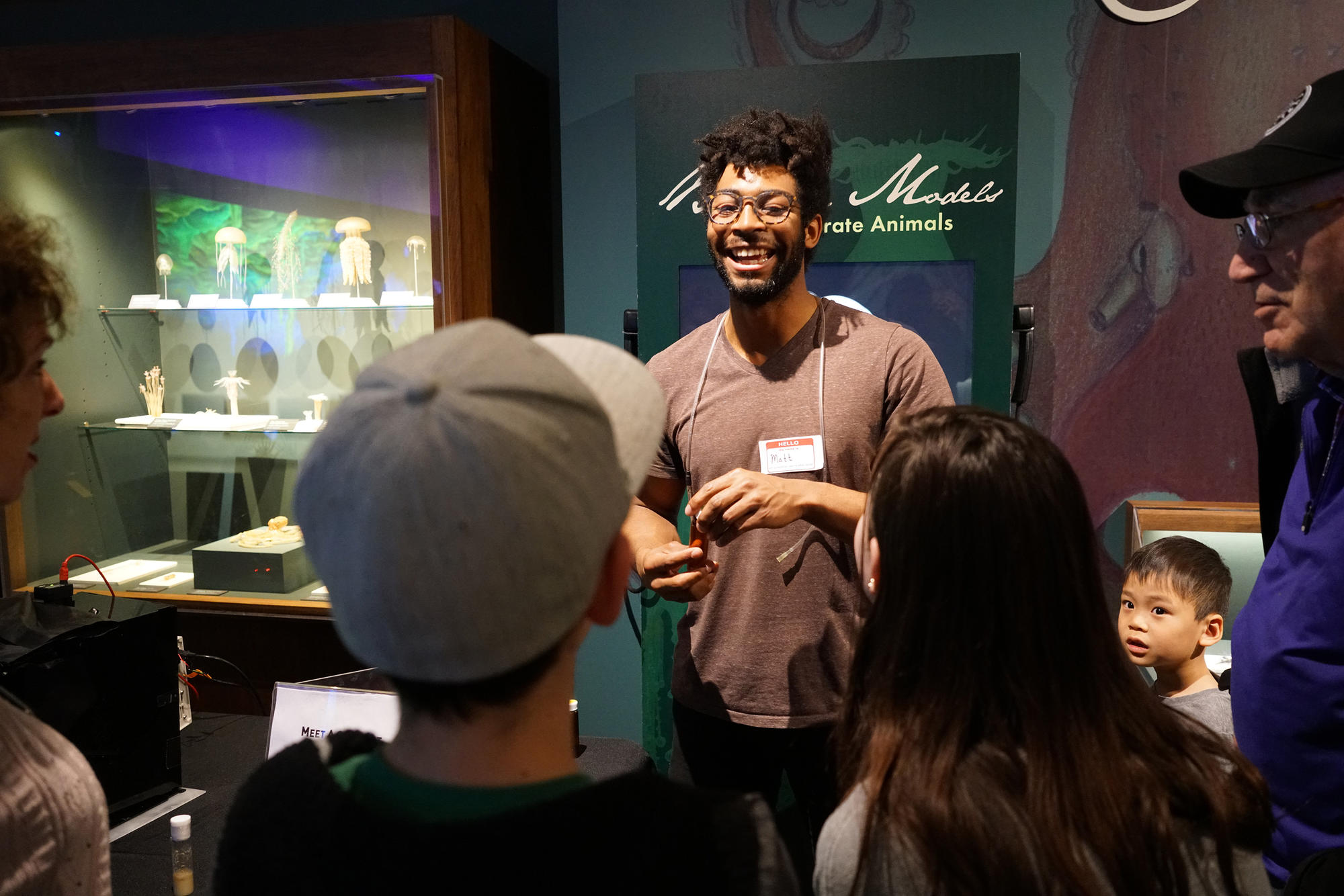 A man talking to a group with kids and adults in the Sea Creatures Gallery.