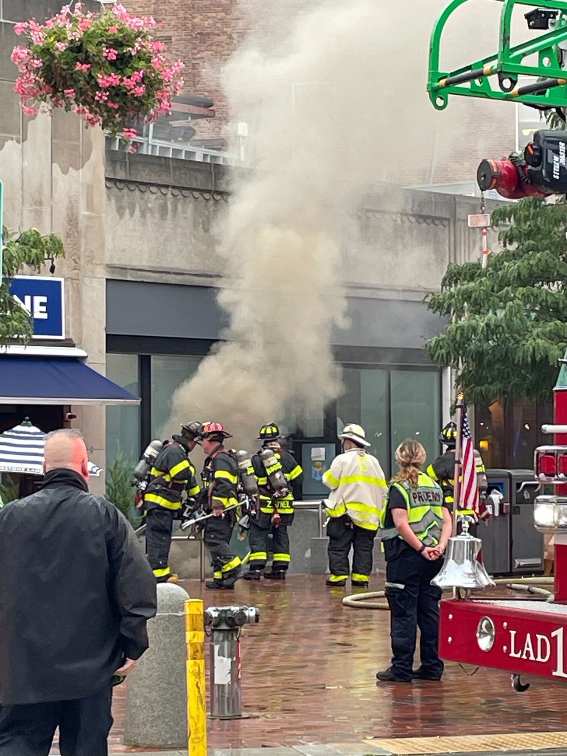 Firefighters observe smoke rising from the scene of a manhole explosion at 27 Brattle Street on Wednesday morning.