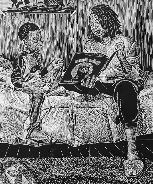A black and white print shows a mother sitting on a bed and reading to her son before bedtime.