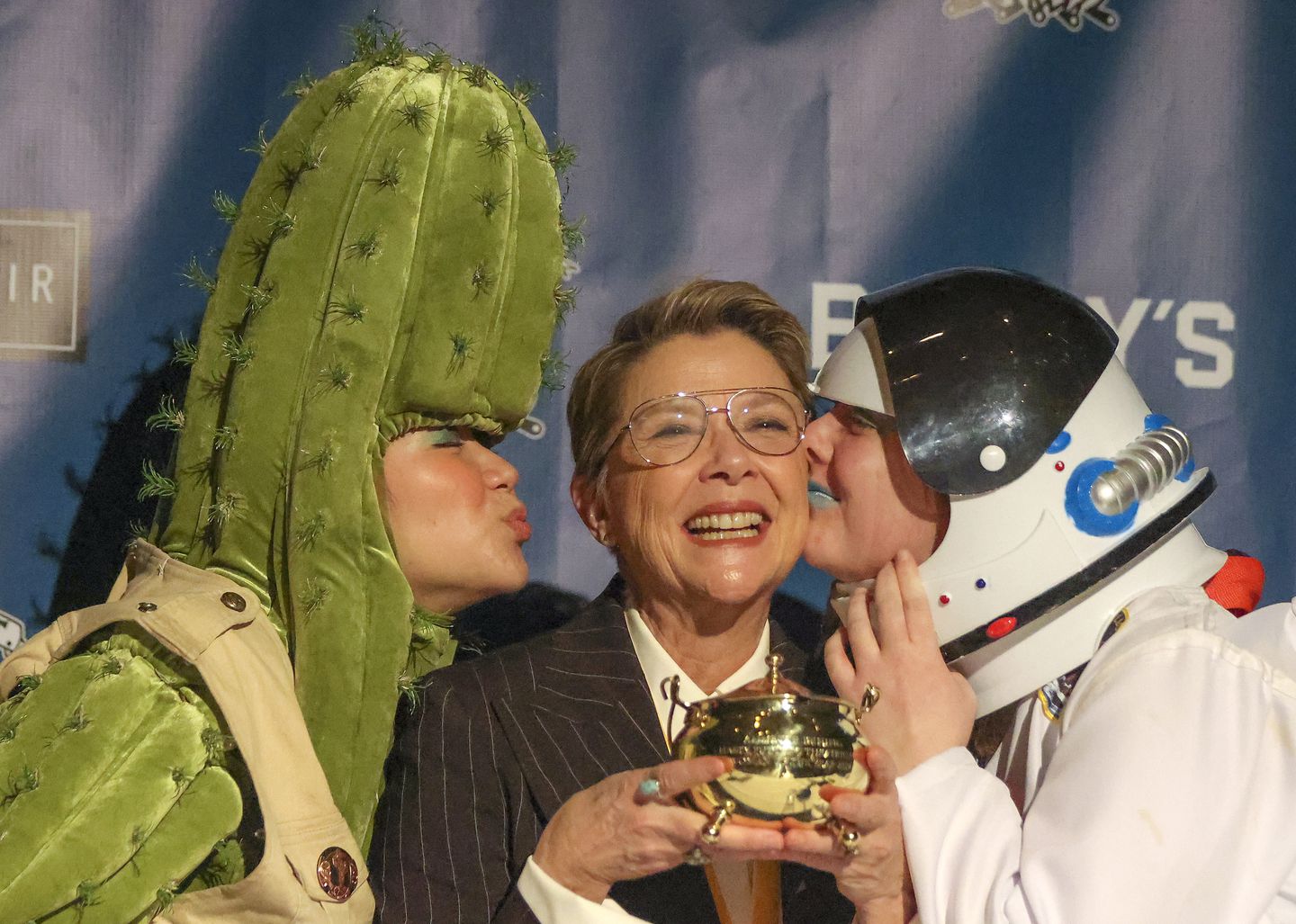 Annette Bening received kisses from Crystal Manyloun, left, and Maureen Clare during the photo session after the Hasty Pudding Roast.



