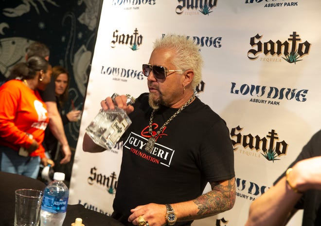 On May 3, celebrity chef and television host Guy Fieri visits Low Dive in Asbury Park, signing bottles of his tequila company, Santo Spirits.