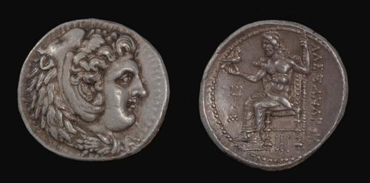 Two irregularly shaped silver-gray coins with relief decoration on each: the one at left is a profile of a man; the one at right is a man in a throne.