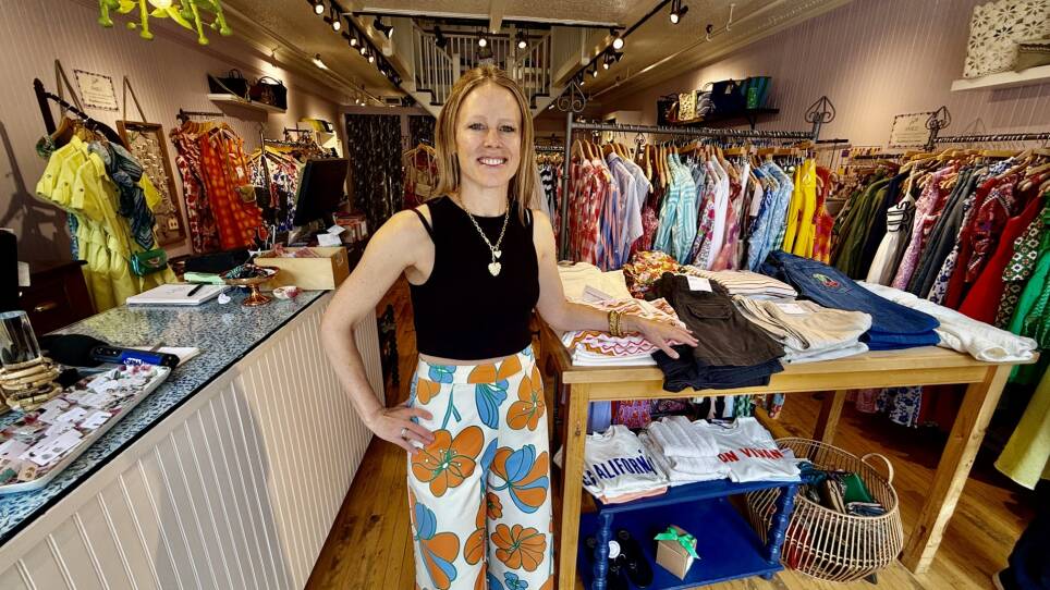 Store owner posing for photo on the sales floor of her boutique in Cambridge